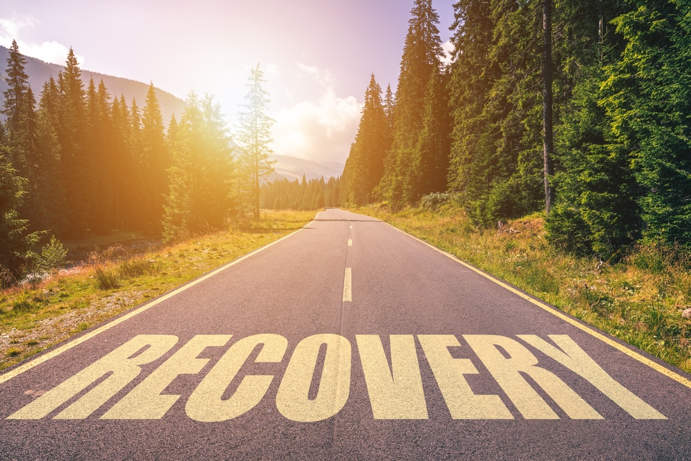 A road with the word "Recovery" superimposed